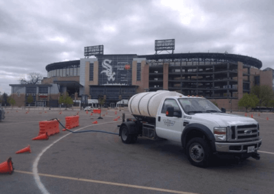 Tank Truck Filling Barricades in Preparation for Road Race