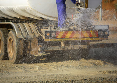 An up-close shot of dust control formula being sprayed from a Gasaway Maintenance Company truck.
