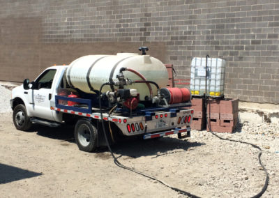 Small Water truck makes delivery to brick layer at a construction site