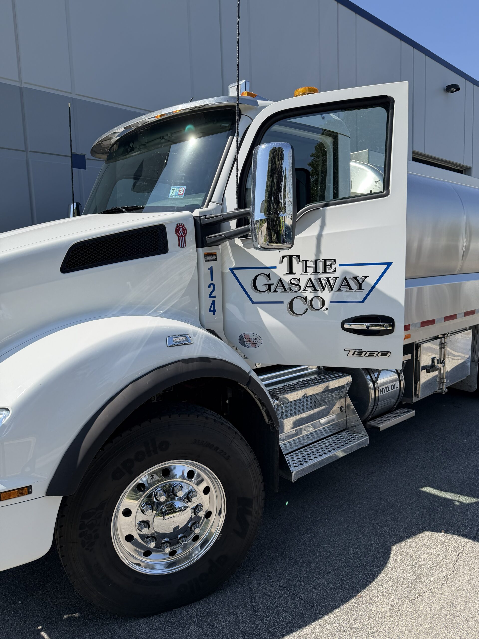 A Gasaway Maintenance Company water truck shining in the sunlight with its door open, displaying the company logo.